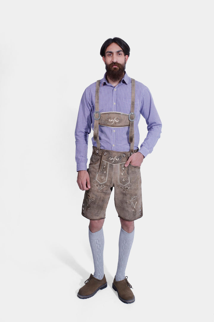 complete view of man wearing traditional lederhosen suspenders