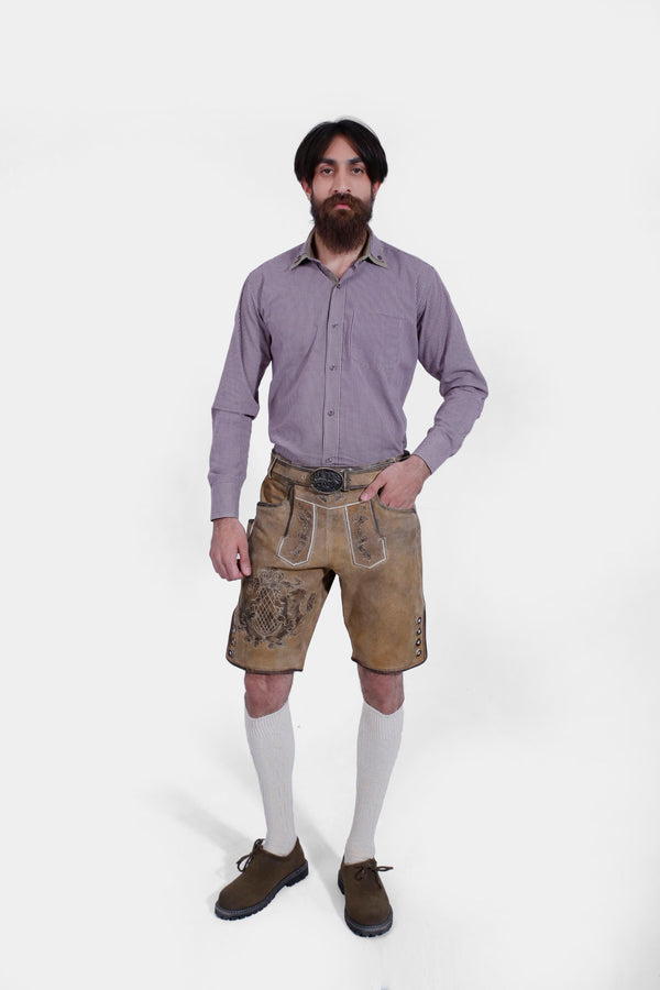 Full front view of man in Boris Becker Lederhosen, checkered shirt, and dark brown shoes.