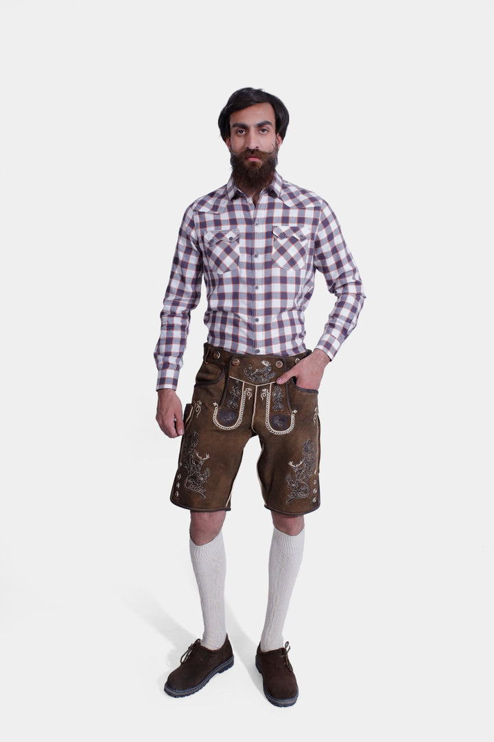 A man showcases "Chestnut Oak" lederhosen made of high-grade goat suede leather in smoky used-brown, featuring traditional Bavarian embroidery, real horn buttons, and adjustable lacing for a perfect fit. braune lederhose, lederhose braun herren