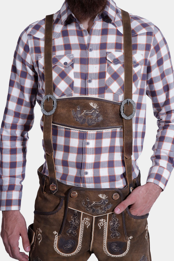 man wearing traditional lederhosen suspenders