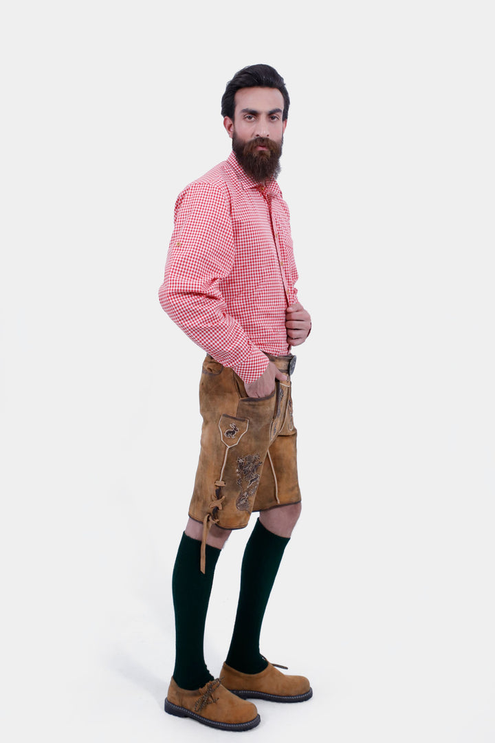 Side view of a man wearing Chiemsee Lederhosen and a pink checkered shirt, showing the fit and style of the shorts.