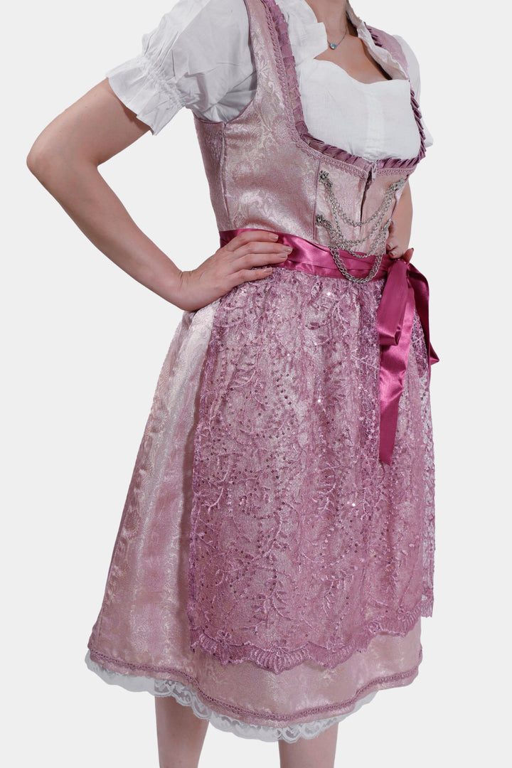 Left side view of Dirndl Jessica Schwarz showing detailed lace patterns on the apron and sparkling embellishments on the bodice.