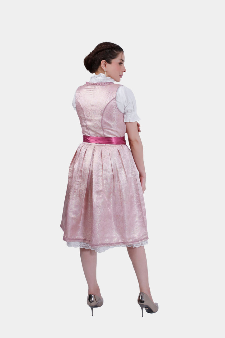 Rear view of a woman in Dirndl Jessica Schwarz, highlighting the lace-up back detail and the flowing rose skirt.