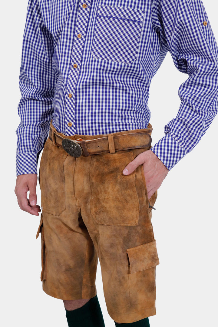 A frontal view of the Franzl Lang Cargo Lederhosen in Tuscan Sunburst, highlighting the intricate design and pockets, paired with a blue and white checkered shirt.