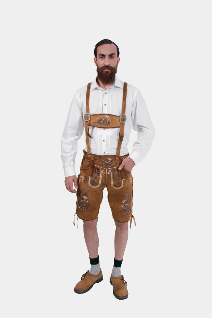 complete view of a man wearing traditional lederhosen suspenders with intricate embroidery in natural colors