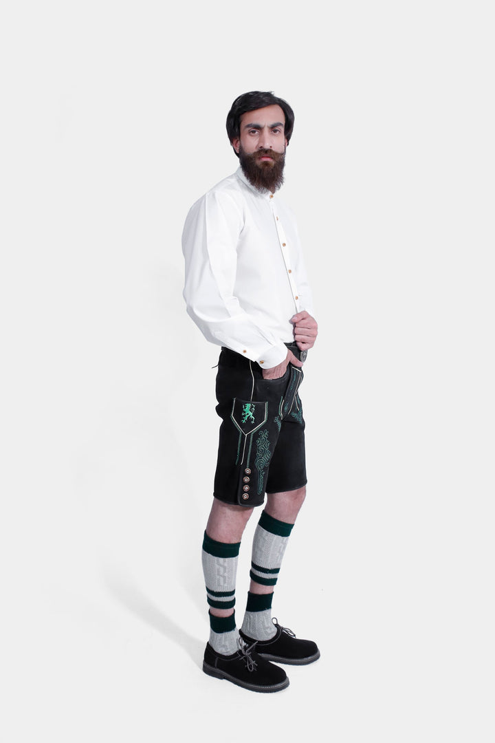 Man wearing Gropius Lederhosen, highlighting the front green embroidery and traditional craftsmanship.