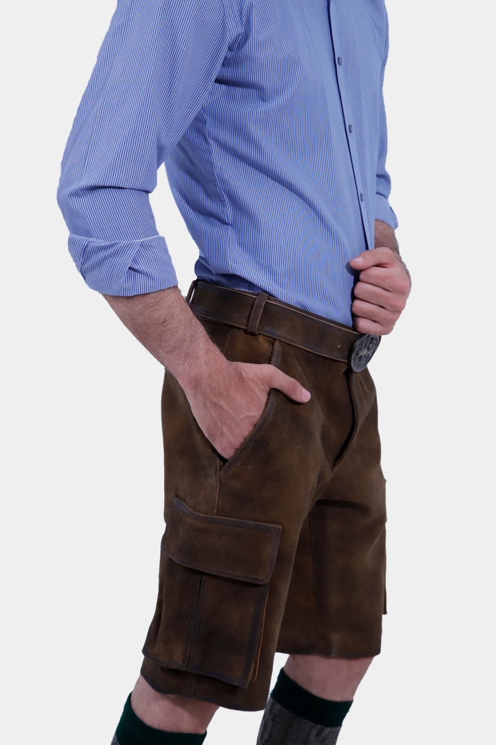 Side view of a man in Hallstatt Cargo Lederhosen and a blue checkered shirt, showing the fit and pockets of the traditional Bavarian leather shorts.