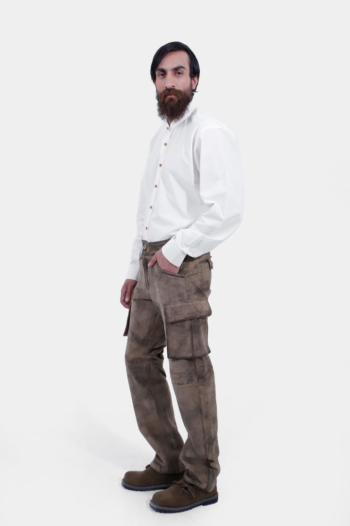 Profile view of a person wearing Königssee Cargo Lederhosen Long Pant with detailed embroidery and cargo pockets, paired with a white button-up shirt.