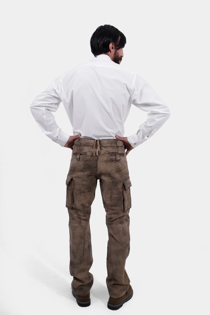 Rear view of a person showing the back of Königssee Cargo Lederhosen Long Pant with a pocket detail, wearing a white button-up shirt.