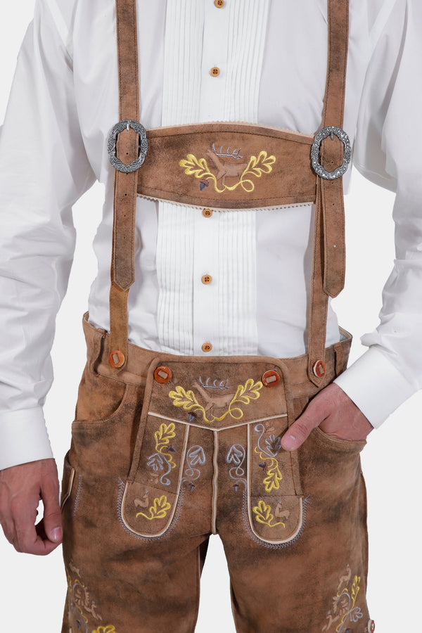 man wearing traditional lederhosen suspenders