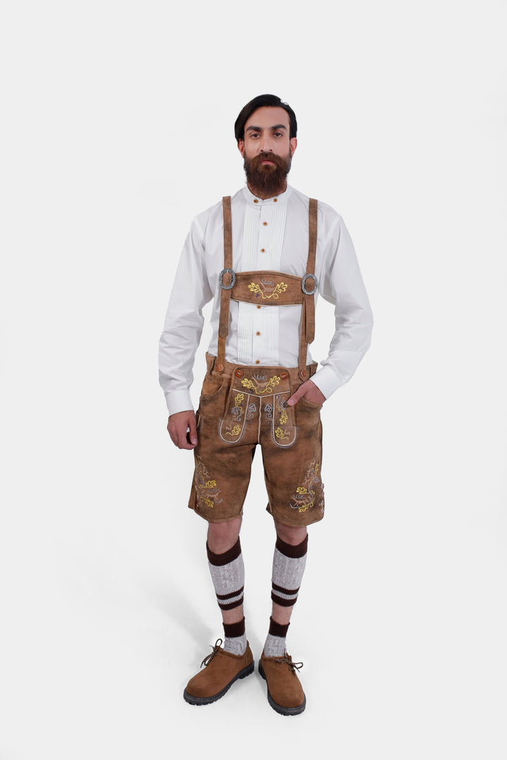 complete view of a man wearing traditional lederhosen suspenders with comlete lederhosen outfit