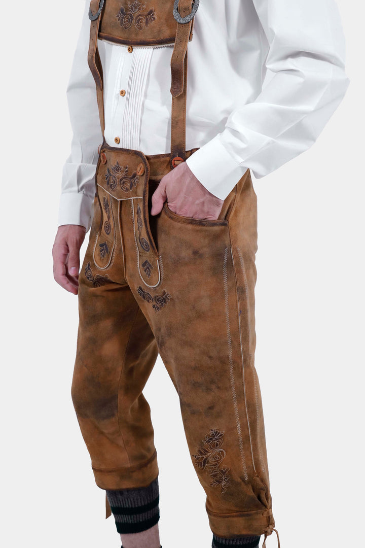 Another side view close-up of Lothar Bundhosen Outfit trousers with suspenders. The focus is on the detailed craftsmanship and design of the brown bundhosen.