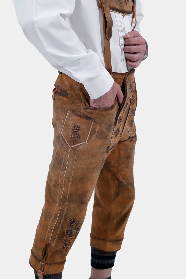 Another side view close-up of Lothar Bundhosen Outfit trousers with suspenders. The focus is on the detailed craftsmanship and design of the brown bundhosen.