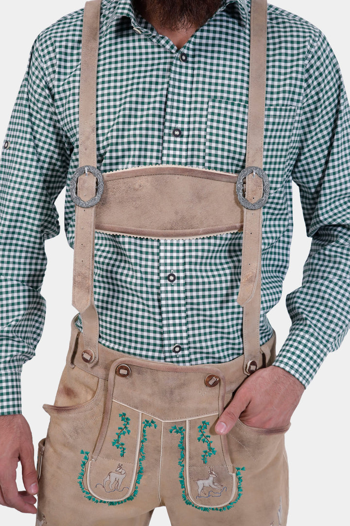 Close-up view of the front of the Luther Lederhosen, focusing on the intricate natural embroidery and brown horn buttons on the leg cuffs.