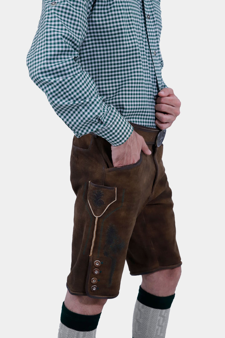 Back view of the man wearing the Mahler Lederhosen, showcasing the leather material and the design on the back pockets.