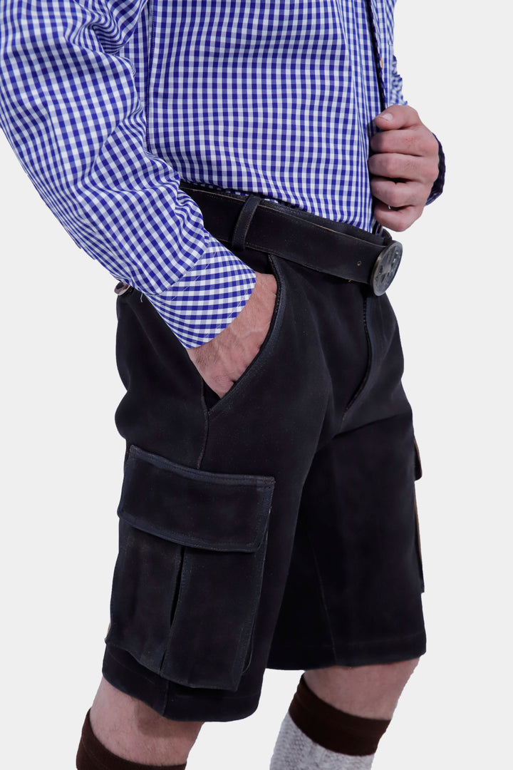 Close-up side view of Manor Oktoberfest Cargo Lederhosen worn by a man, emphasizing the quality leather, pocket details, traditional knee-high socks, and brown shoes.