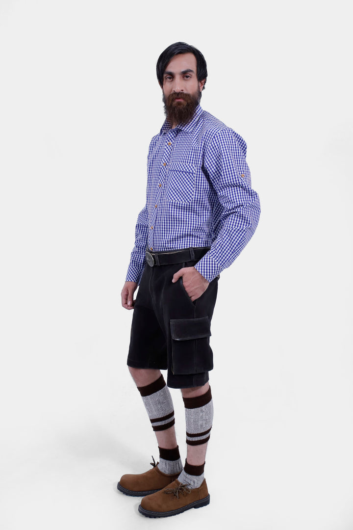 Side view of a man wearing Manor Oktoberfest Cargo Lederhosen, highlighting the cargo pockets and traditional design, paired with brown shoes and  knee-high socks, 