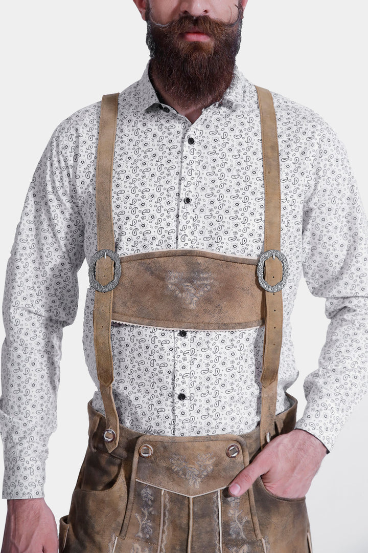 Close-up view of a man wearing Mozart Lederhosen with a white patterned shirt, showcasing the detailed suspenders and traditional Bavarian style.