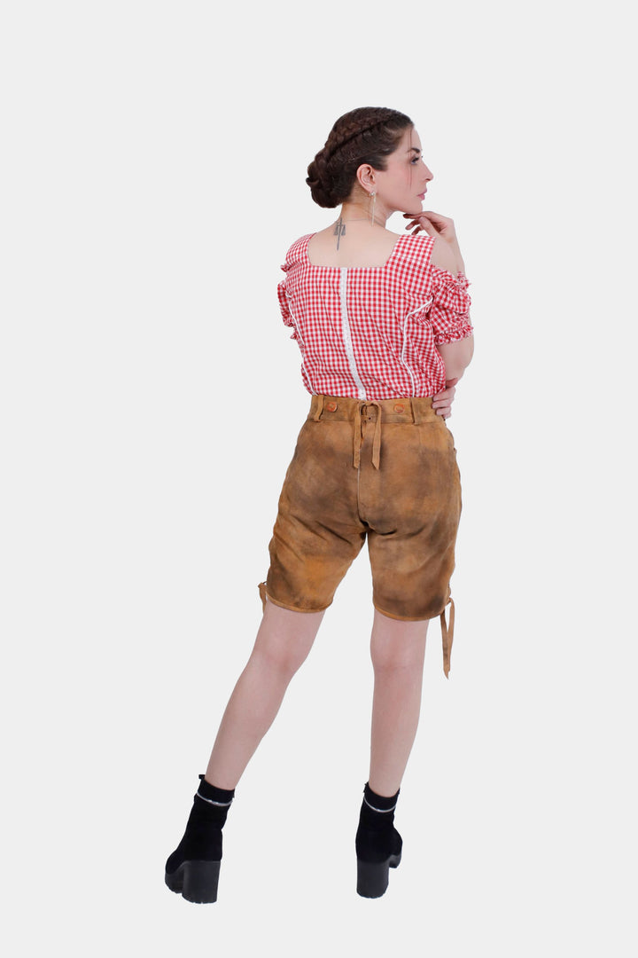 Rear view of a woman in Munich Majesty lederhosen, displaying the back waistband and the overall fit of the shorts.