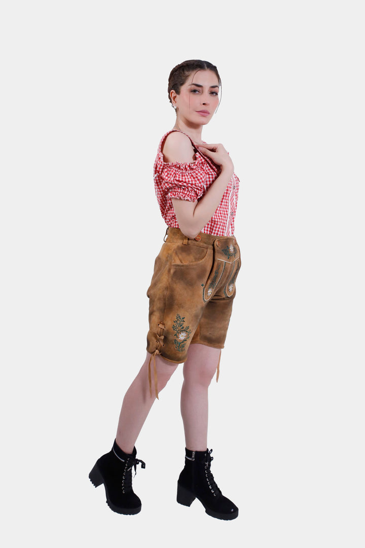 Side profile of a woman in Muncih Majesty lederhosen, and the detailed embroidery.