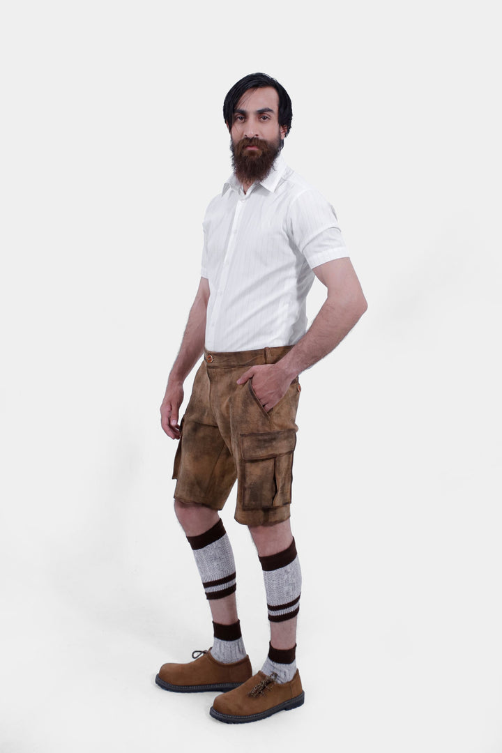 Side view of a man wearing Snowbird Cargo Lederhosen, highlighting the cargo pockets and traditional design, paired with brown shoes and knee-high socks