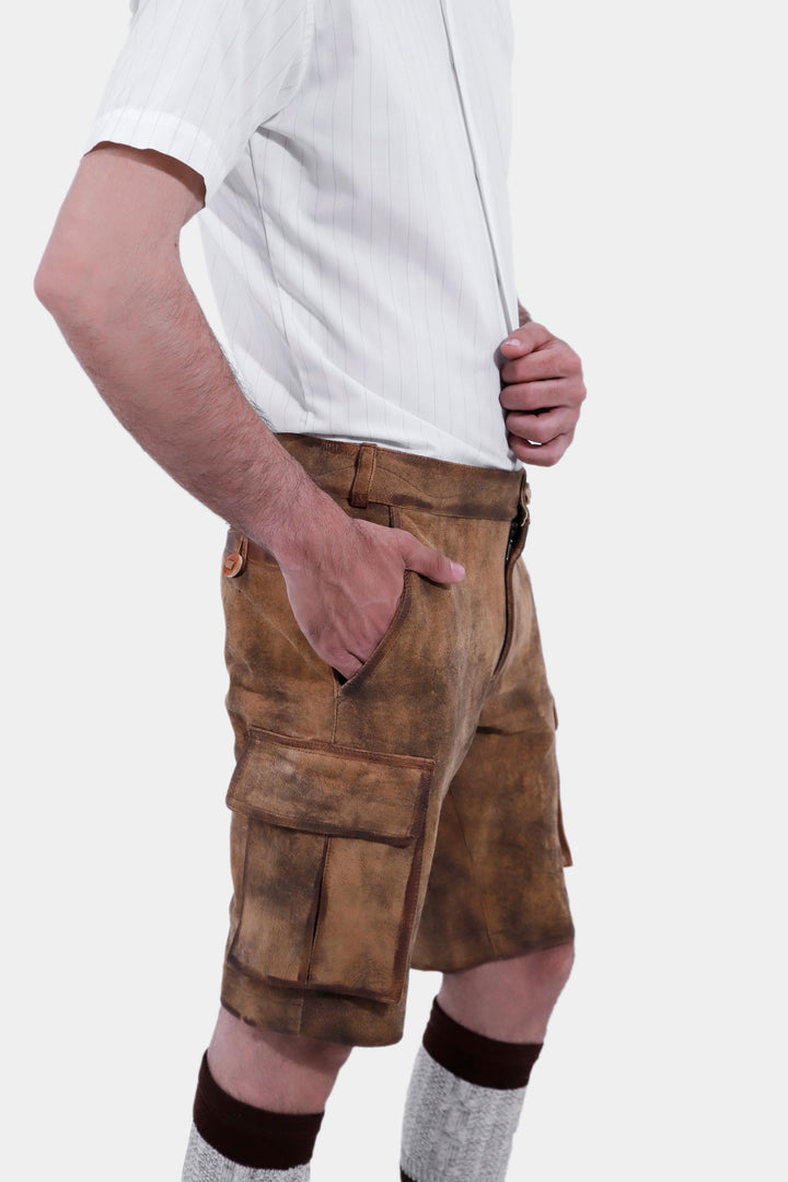 Close-up side view of Snowbird Cargo Lederhosen worn by a man, emphasizing the quality leather, pocket details, traditional socks, and brown shoes.