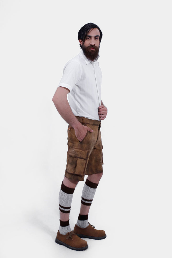 Side profile of a man in Snowbird Cargo Lederhosen, capturing the traditional Bavarian style, modern cargo features, knee-high socks, and brown shoes.