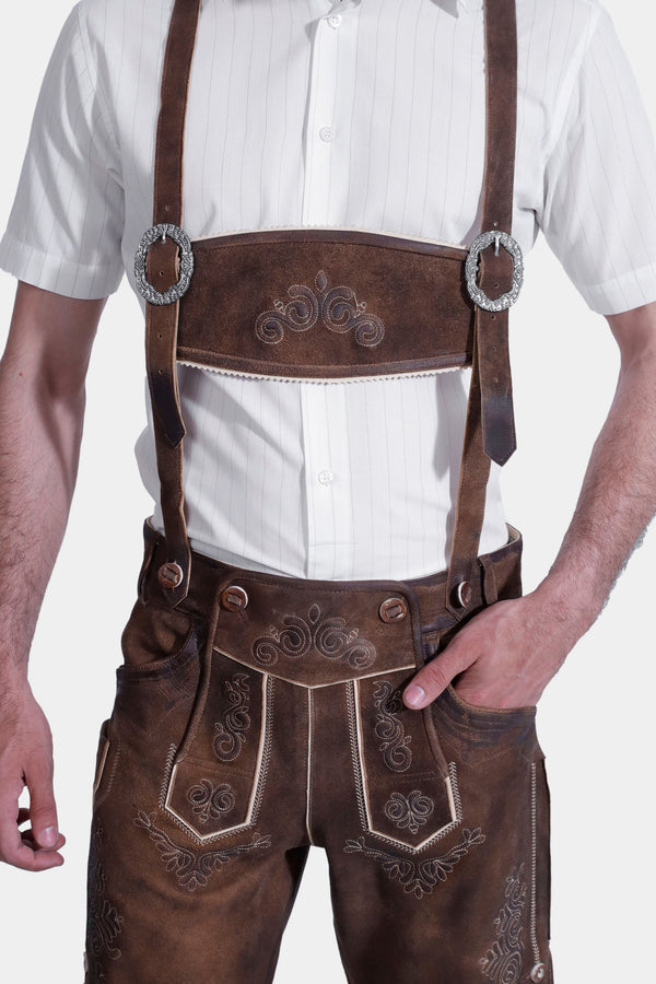 man wearing traditional lederhosen suspenders