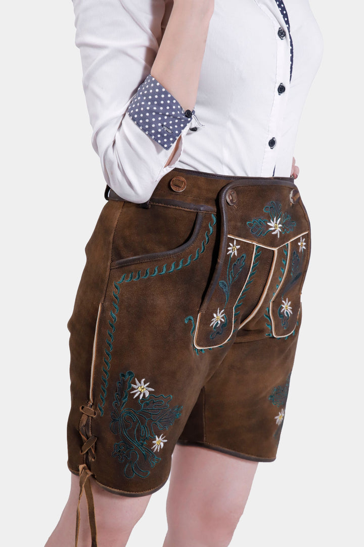 Woman posing in Romy Schneider lederhosen, emphasizing the knife pocket on the side and the elegant embroidery detail.