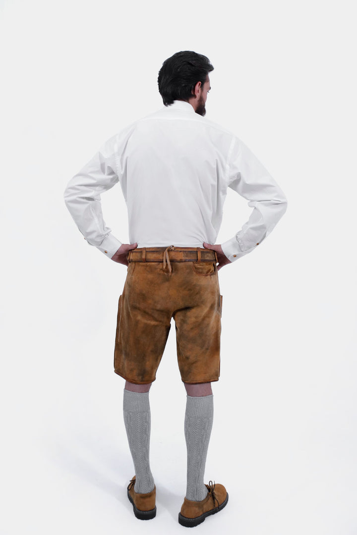 Back view of the man wearing the Rothenburg Lederhosen, showcasing the leather material and the design on the back pockets.