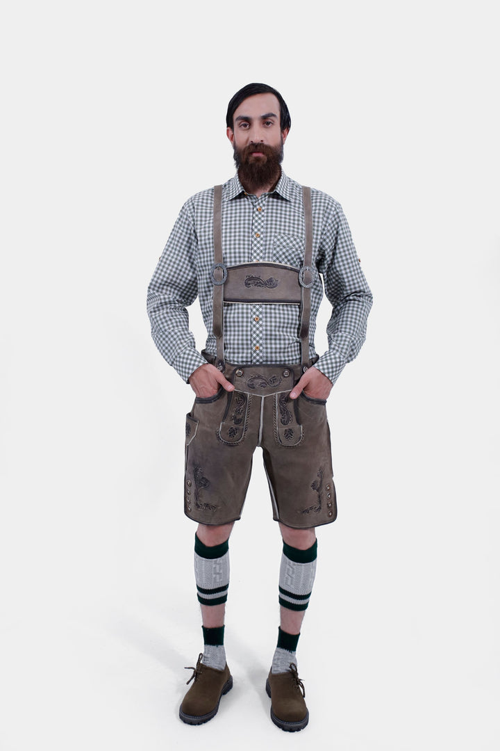 complete view of man wearing traditional bavrian lederhossen suspenders