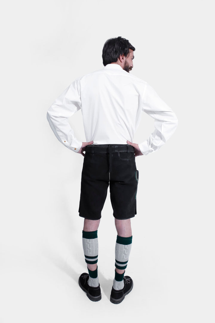 Rear view of the Schümann Lederhosen Outfit, displaying the black leather lederhosen, white shirt, and knee-high socks from behind.