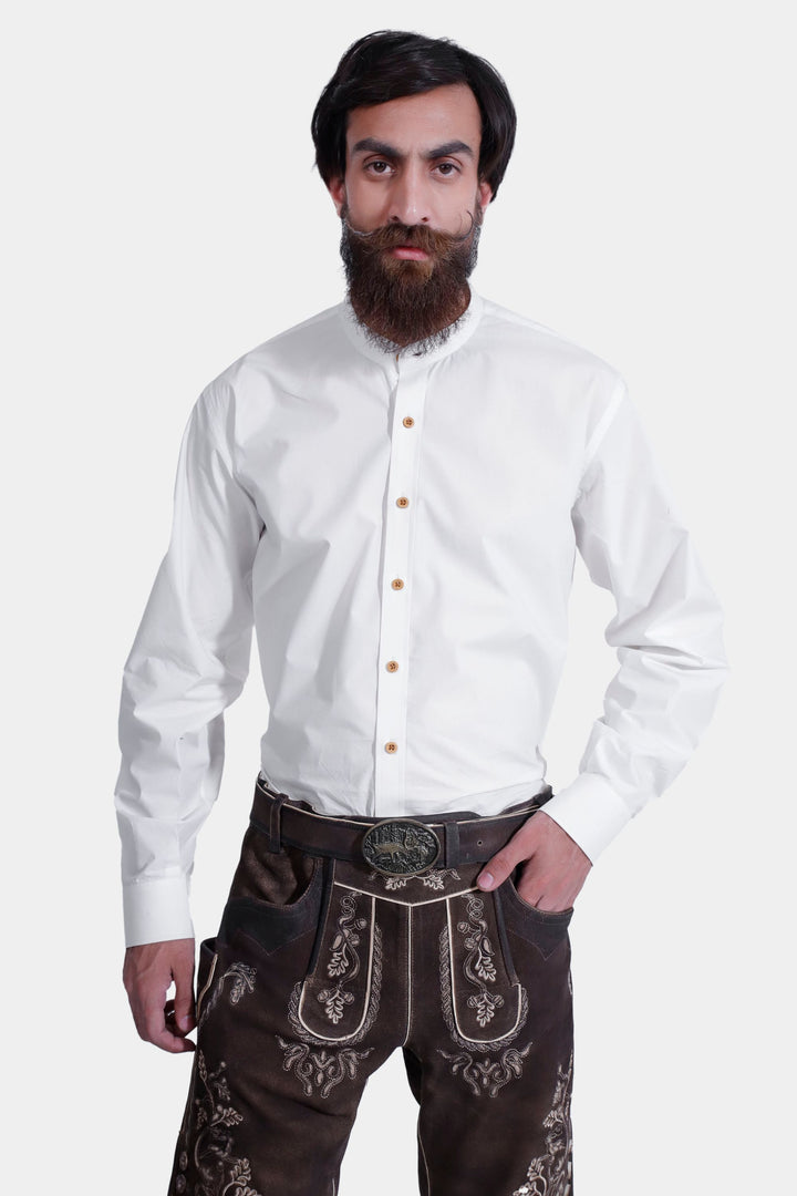 Close-up of a model wearing Spiegel Lederhosen, highlighting the detailed embroidery on the leather shorts and the front design, paired with a white button-down shirt.