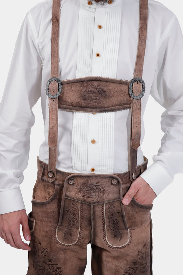 man wearing traditional lederhosen suspenders