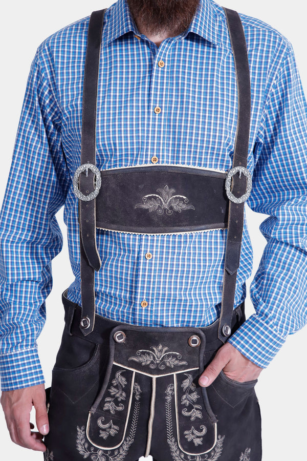 man wearing traditional lederhosen suspenders