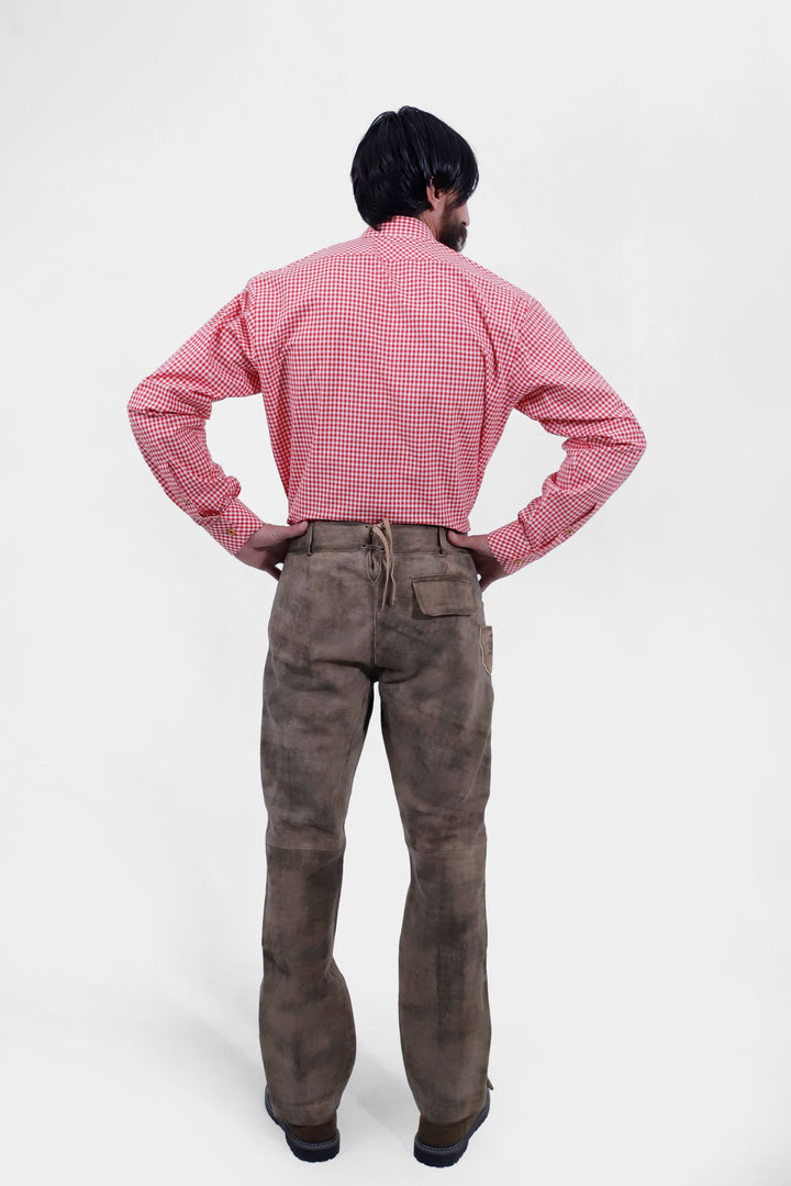 Rear view of a person showing the back of Wachau Valley Lederhosen Long Pant with a pocket detail, wearing a red and white checkered shirt.