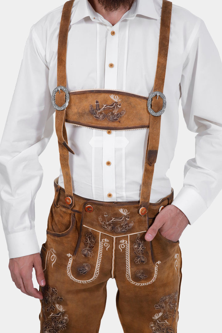 Man in Freud Lederhosen with white dress shirt and black bow tie, close-up on chest and lederhosen front.