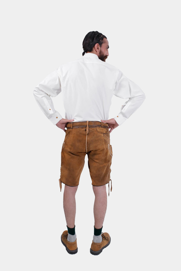 Rear view of a man wearing Freud Lederhosen and white shirt, showcasing the detailed back design and fit.