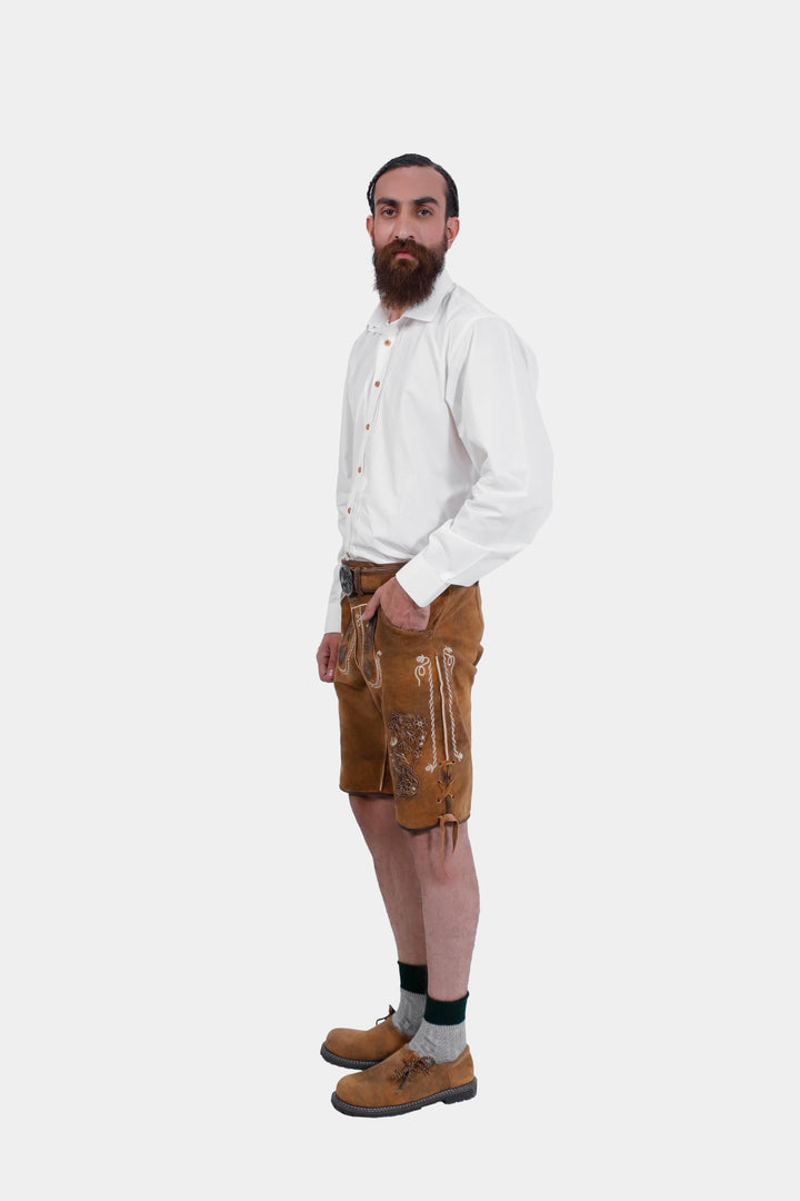 Full body side profile of a man in Freud Lederhosen with a casual pose, featuring embroidered details and knee-length design.