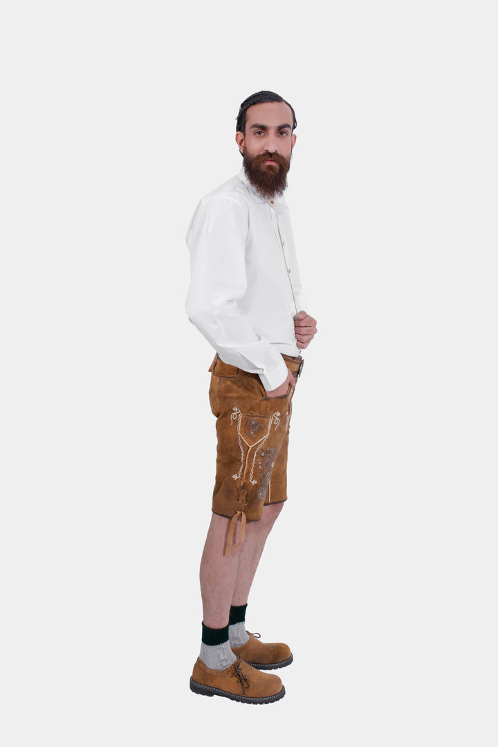 Side profile of man wearing Freud Lederhosen with white dress shirt, black bow tie, and gray knee-high socks.