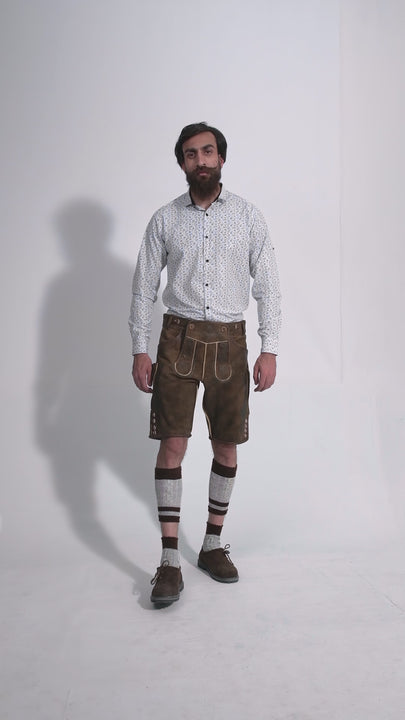 Man showcasing Schubert Lederhosen Lederhosen, rotating to display all angles of the outfit, including front, side, and back views.