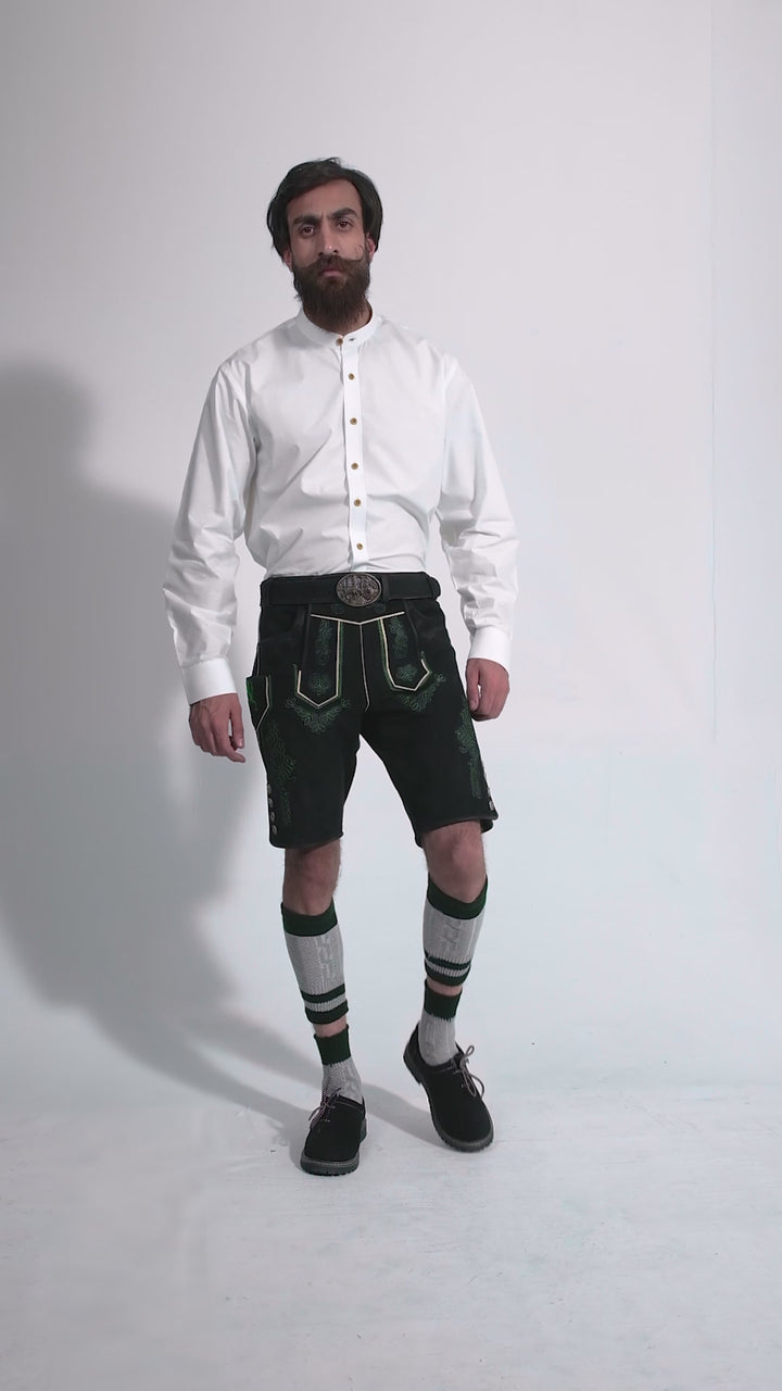 Man showcasing Gropius Lederhosen, rotating to display all angles of the outfit, including front, side, and back views.