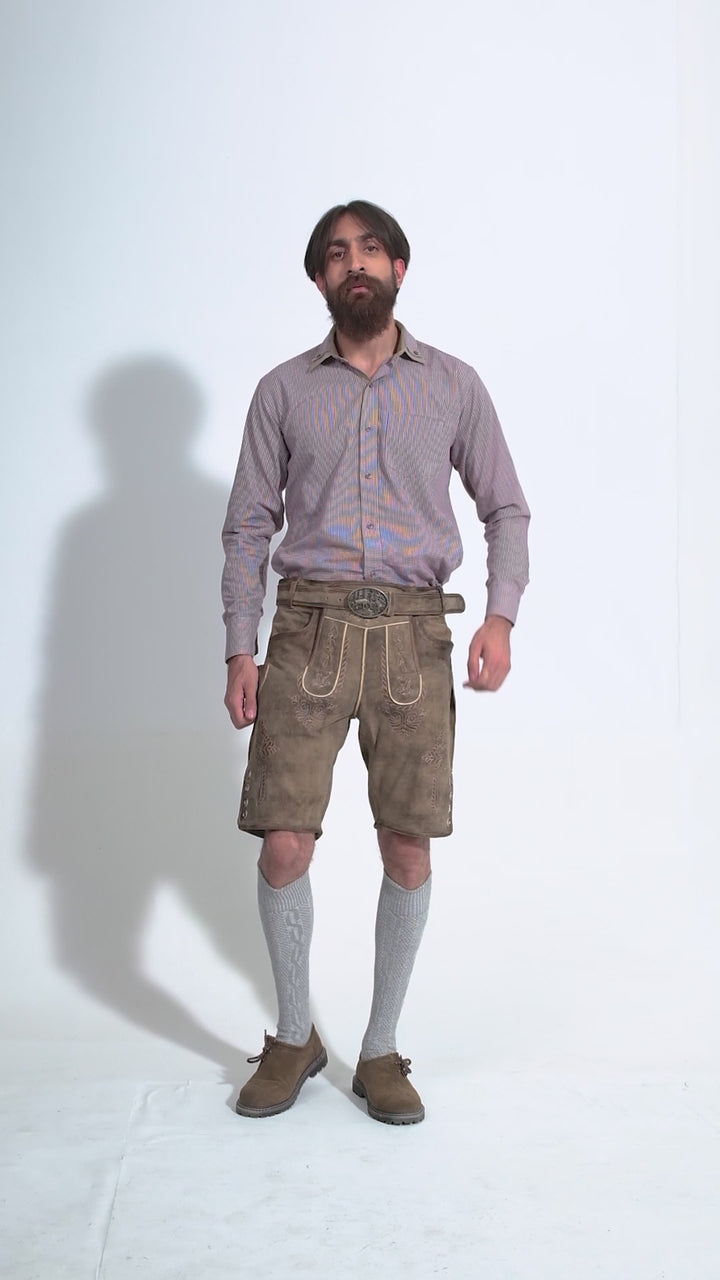 Man showcasing Raphael Lederhosen, rotating to display all angles of the outfit, including front, side, and back views.