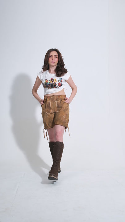 Showcase video of the Stefani Lederhosen, highlighting the product's detailed craftsmanship, rich suede texture, and stylish embroidery through various model poses and close-up shots.