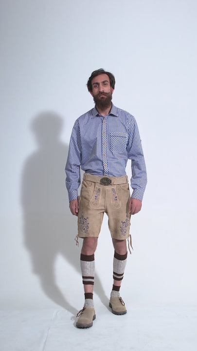 Video showing a 360-degree view of the beige-colored Cincinnati Lederhosen worn by a man in a blue checkered shirt and beige-colored shoes, highlighting the detailed craftsmanship, embroidery, and features of the traditional Bavarian leather shorts.